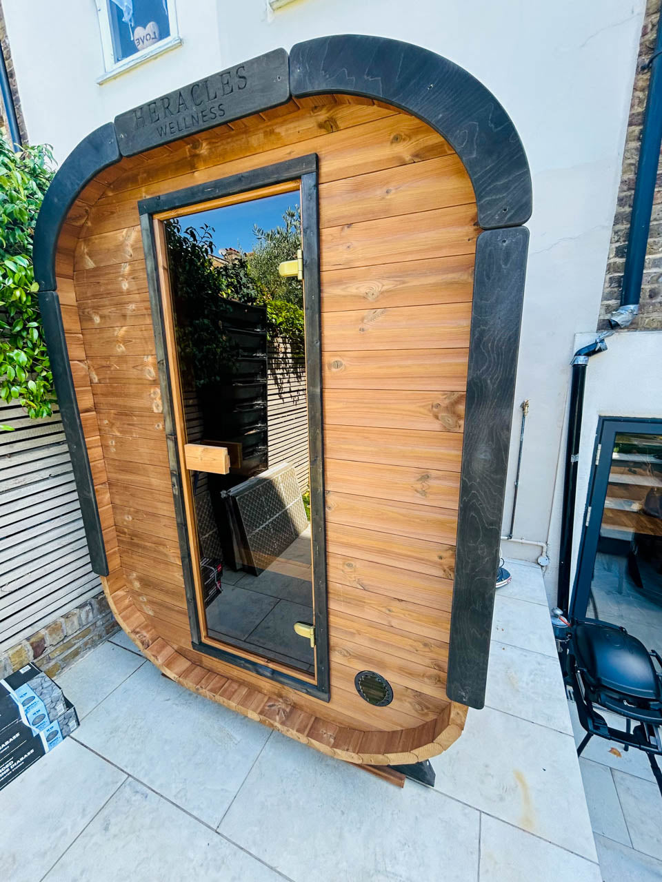 Camilla Compact outdoor sauna kit installed in a garden