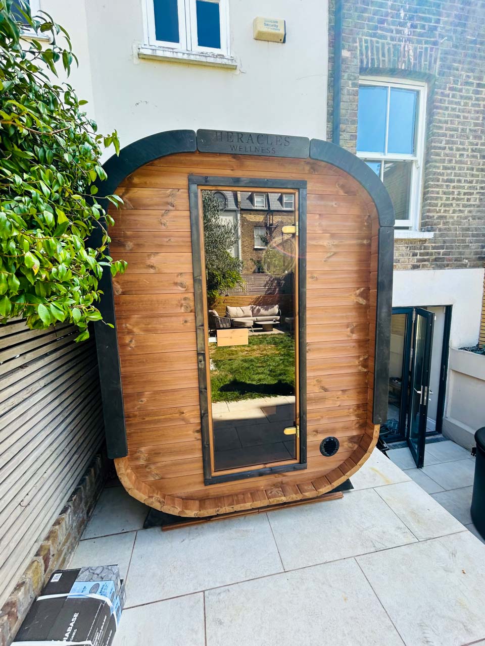 Camilla Compact two-person outdoor sauna in a garden setting