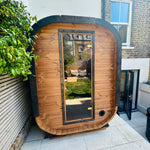 Camilla Compact two-person outdoor sauna in a garden setting