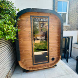 Camilla Compact two-person outdoor sauna in a garden setting