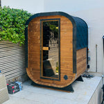 Camilla Compact outdoor sauna beside a garden patio