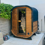 Camilla Compact outdoor sauna beside a garden patio