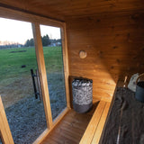 Interior view of the Leil Aris Lite sauna showing the two-level ThermoWood bench and heater position
