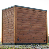 Back view of the Leil Aris Lite outdoor sauna showing ThermoWood rear wall and ventilation opening