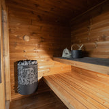 Leil Aris Lite interior showing the sauna heater, lower bench and bronze glass door handles