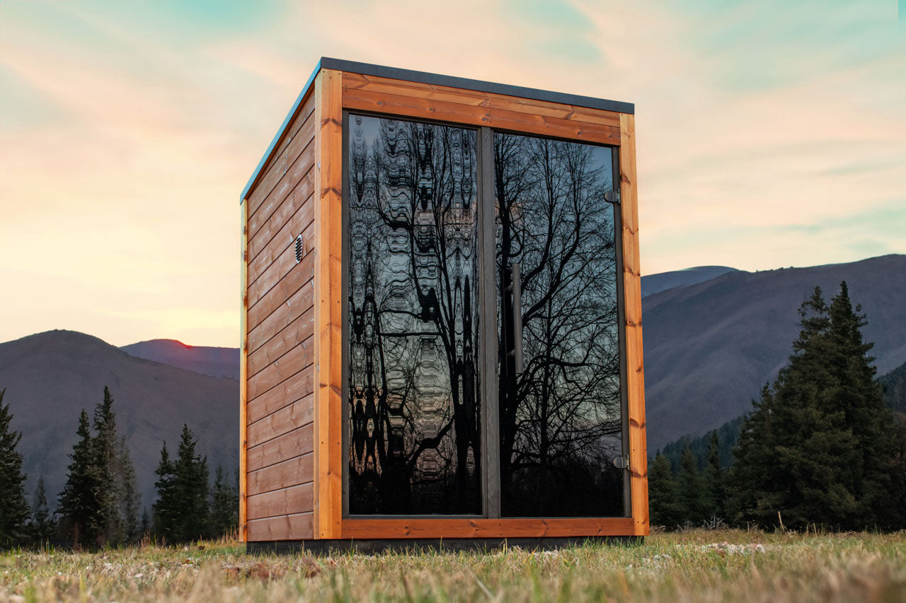 Leil Aris Mini outdoor sauna in garden setting with glass front