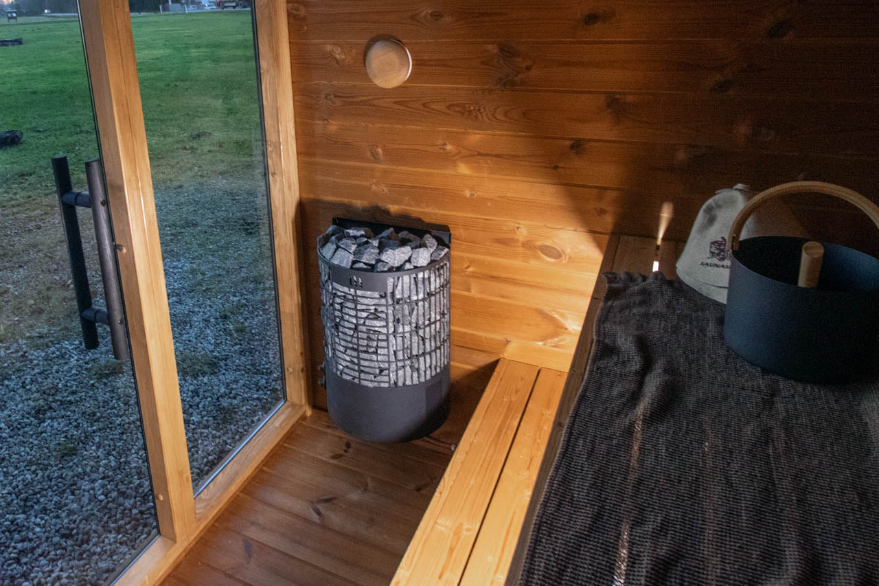 Leil Aris Mini outdoor sauna lifestyle image showing modern garden placement
