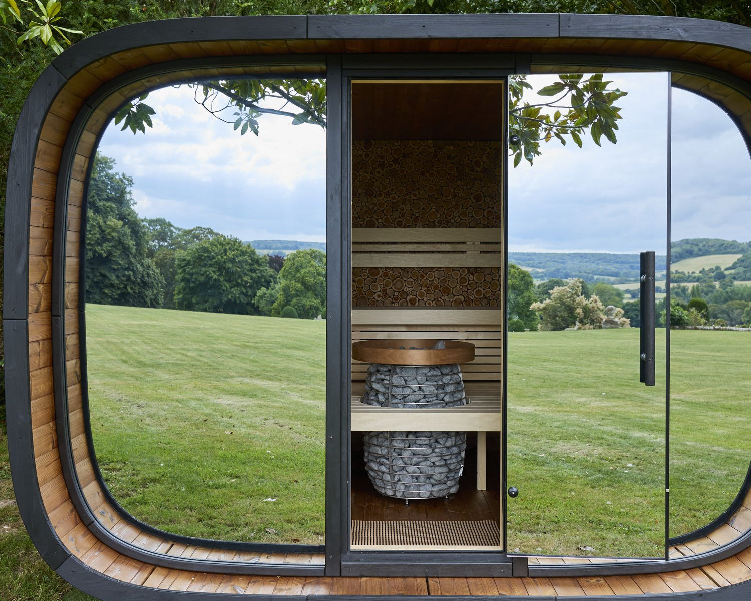 Leil Round Cube Relax installed by Heracles Wellness in a country garden