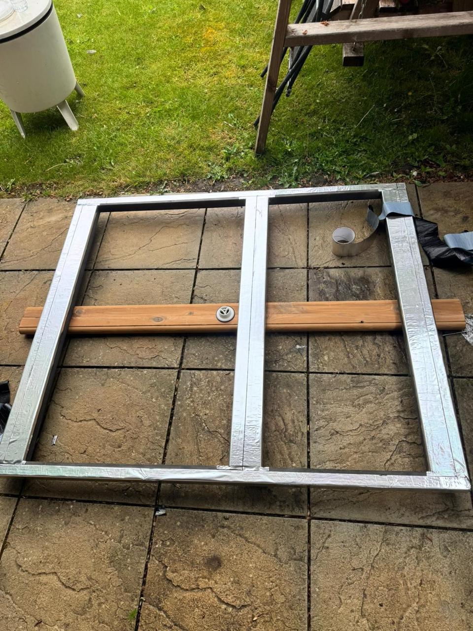 Waterproof membrane applied to an outdoor sauna base frame before assembly